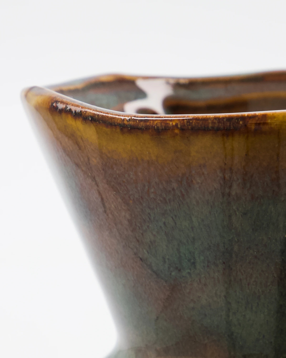 Close-up of a House Doctor HDCorp Vase in Sea Green  with a glossy brown and olive-green glaze on a white background.
