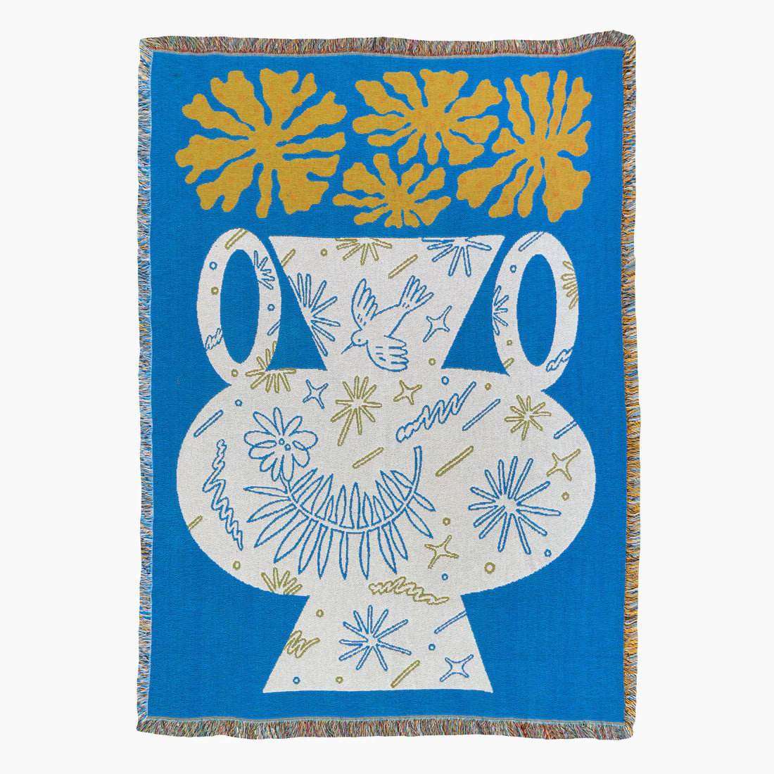 Blue, white and yellow tapestry blanket depicting a white vase and yellow flowers