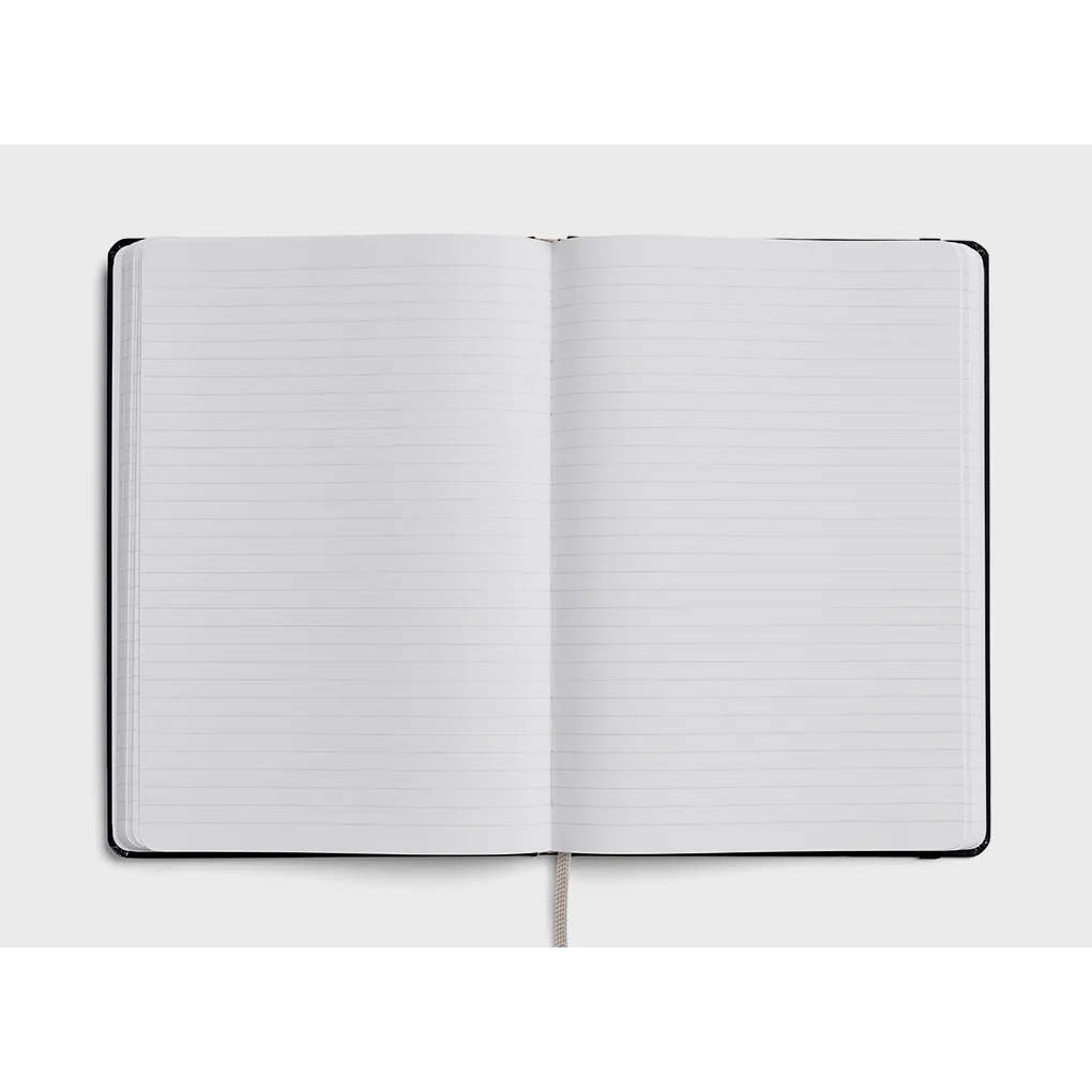 Karst A5 Stone Paper Hardcover Notebook - open to show lined pages with forest green cover 