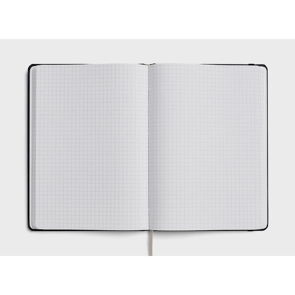 Karst A5 Stone Paper Hardcover Notebook - Grid Pages with black cover. Inside view
