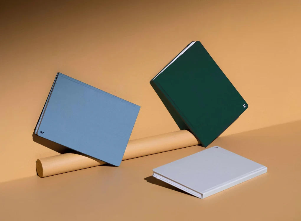 Karst A5 Stone Paper Hardcover Notebook - context image with family of notebooks in forest green, blue and white