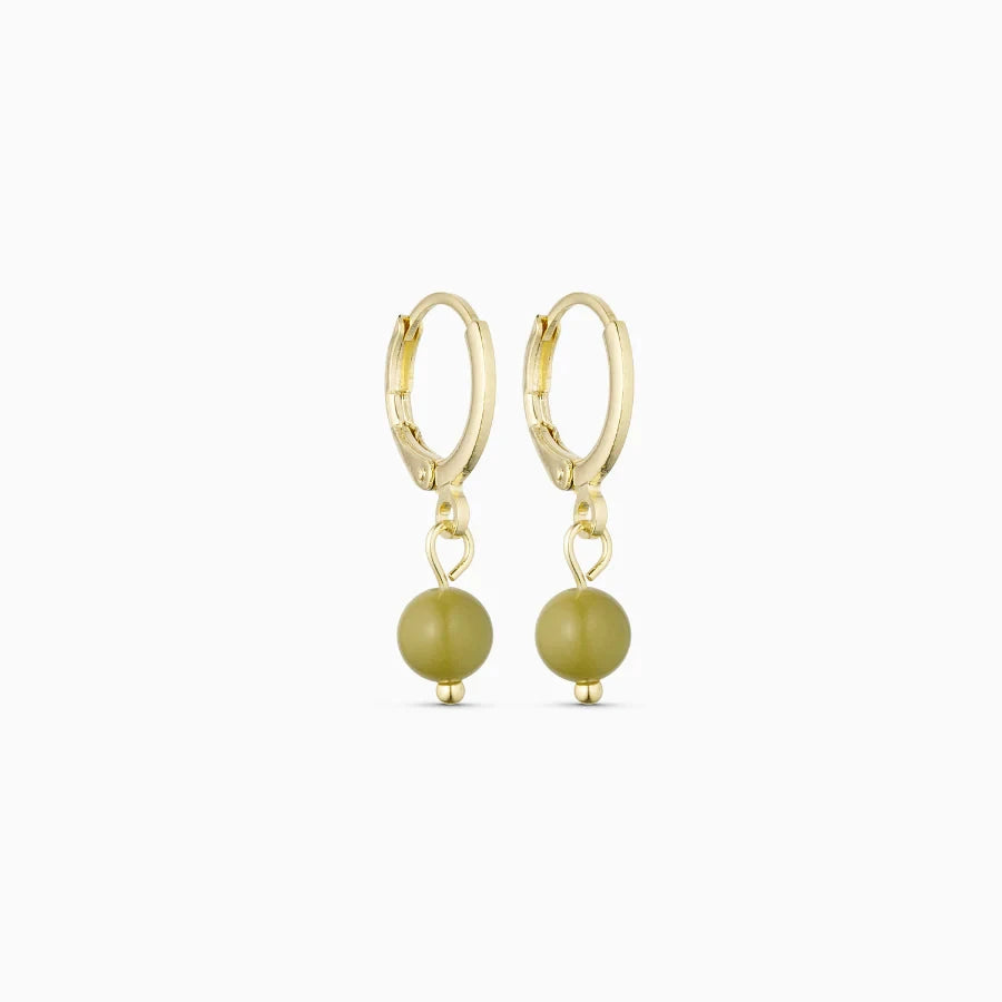 Soï Copenhagen Ava huggie hoop earrings in 18k gold with a Green Alashan Agate stone