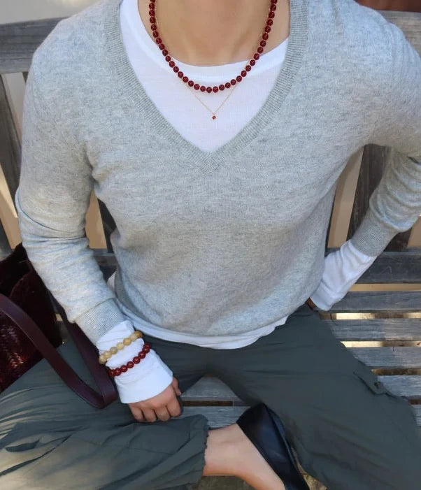 Woman wearing Soï Copenhagen Hailey necklace with Red Jade crystal beads in 18k gold