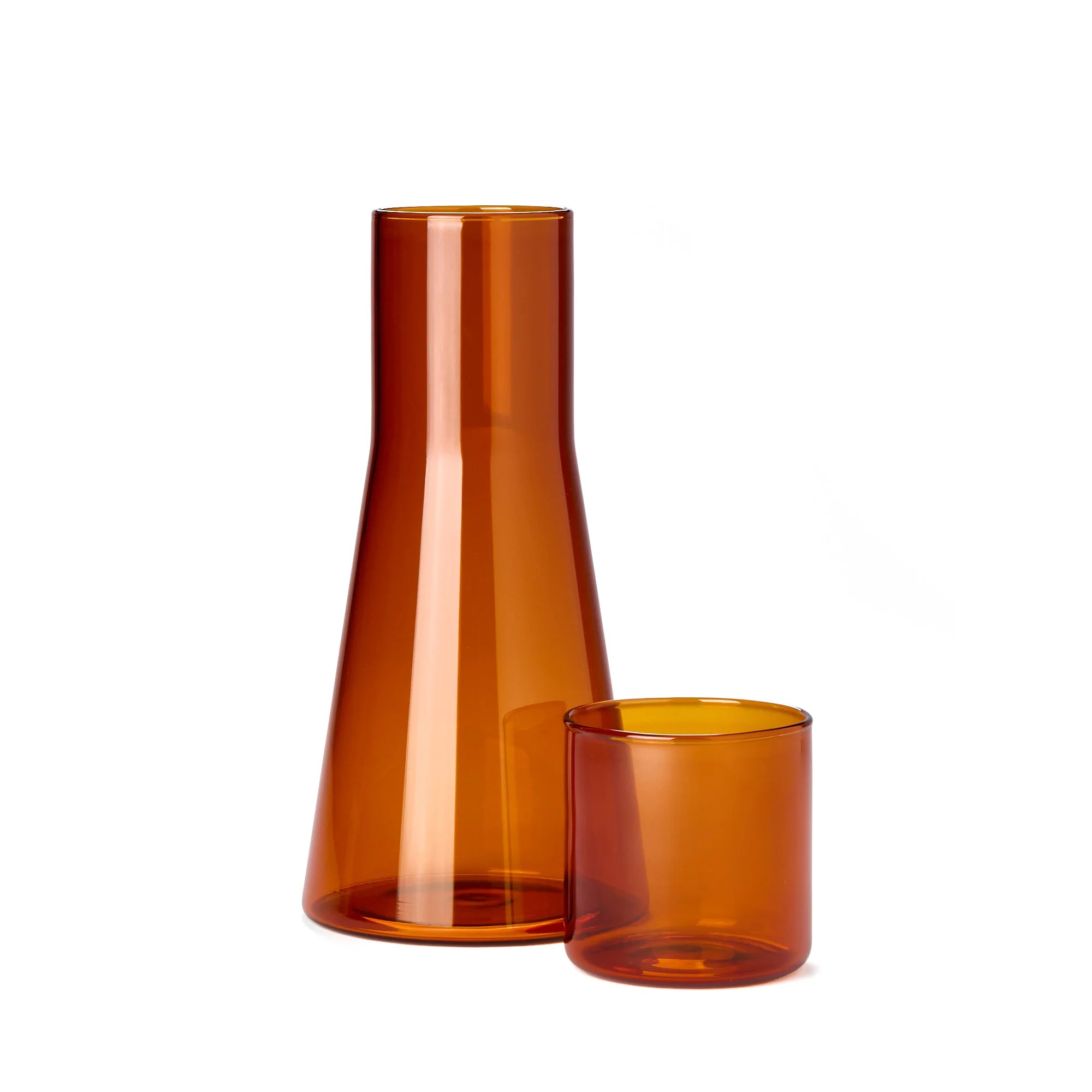 Amber glass carafe and tumbler on a white background