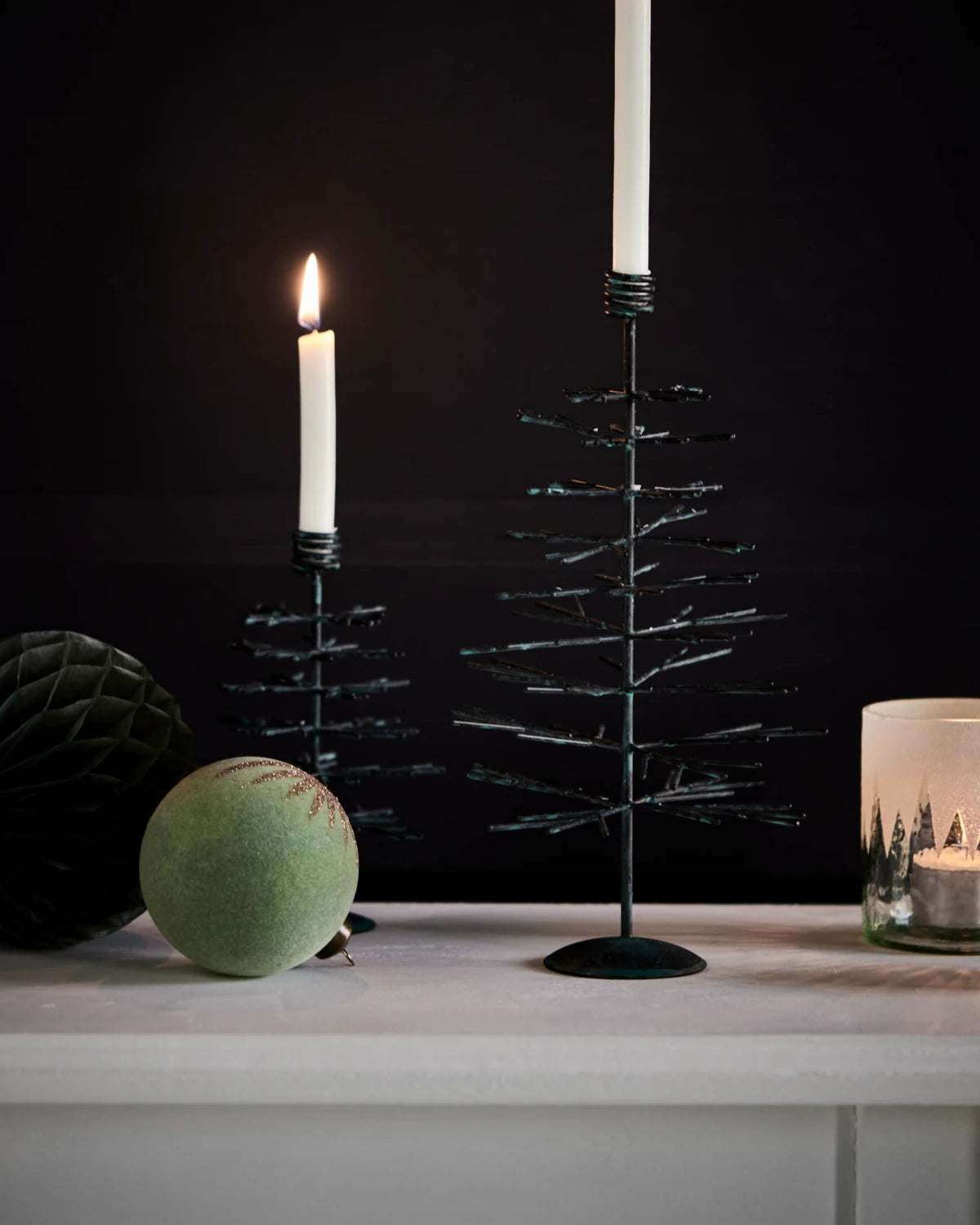 House Doctor 'Tree' Candle Holder Set of 2 in Antique Copper context image with white candles against a dark wall