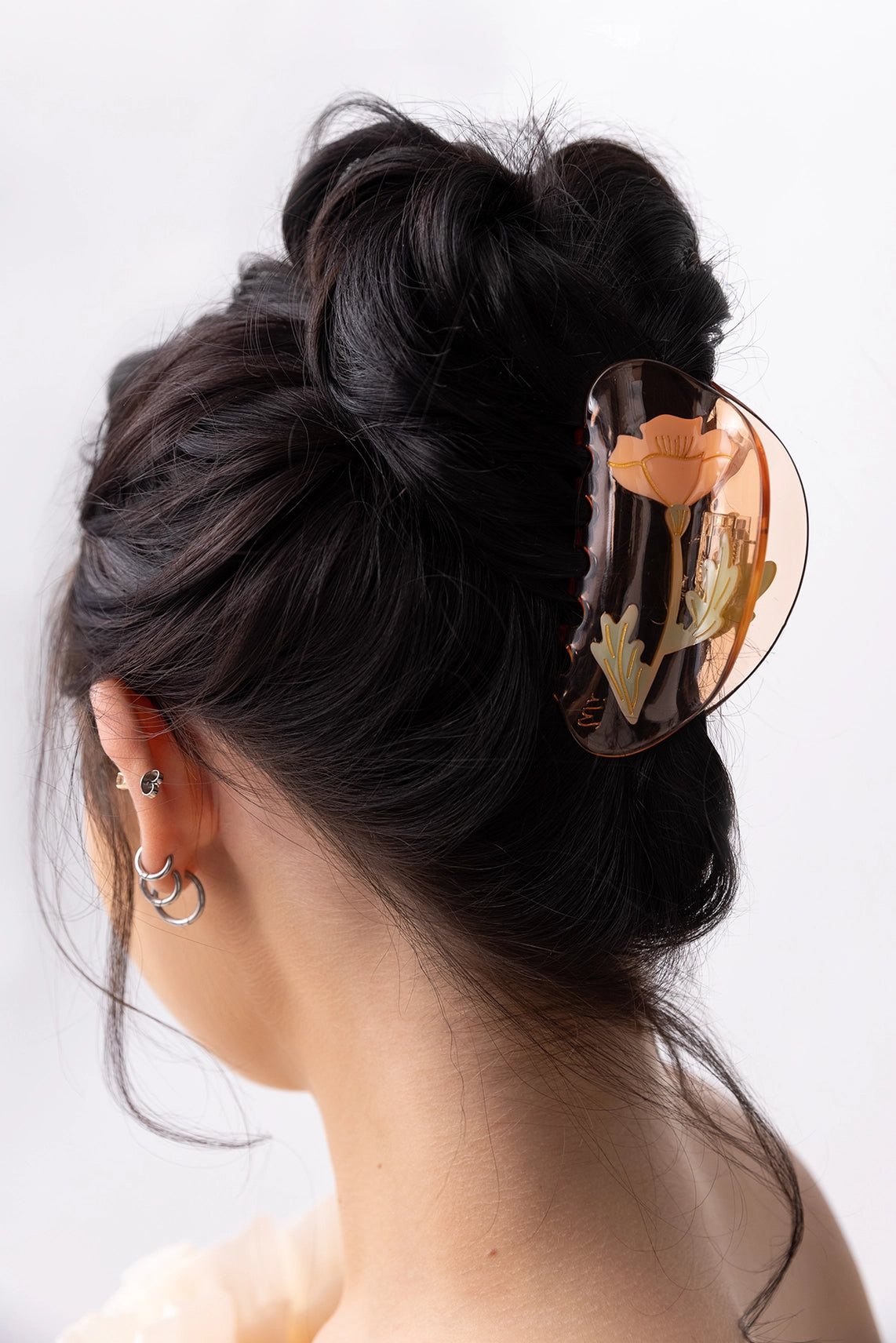 Winona Irene California Poppy Wildflower Acetate Hair Claw being worn in an up do by a model with long dark hair
