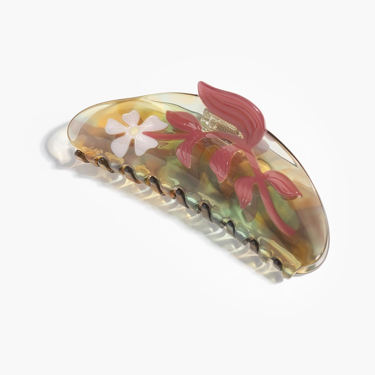 Decorative hair clip with floral design on a white background