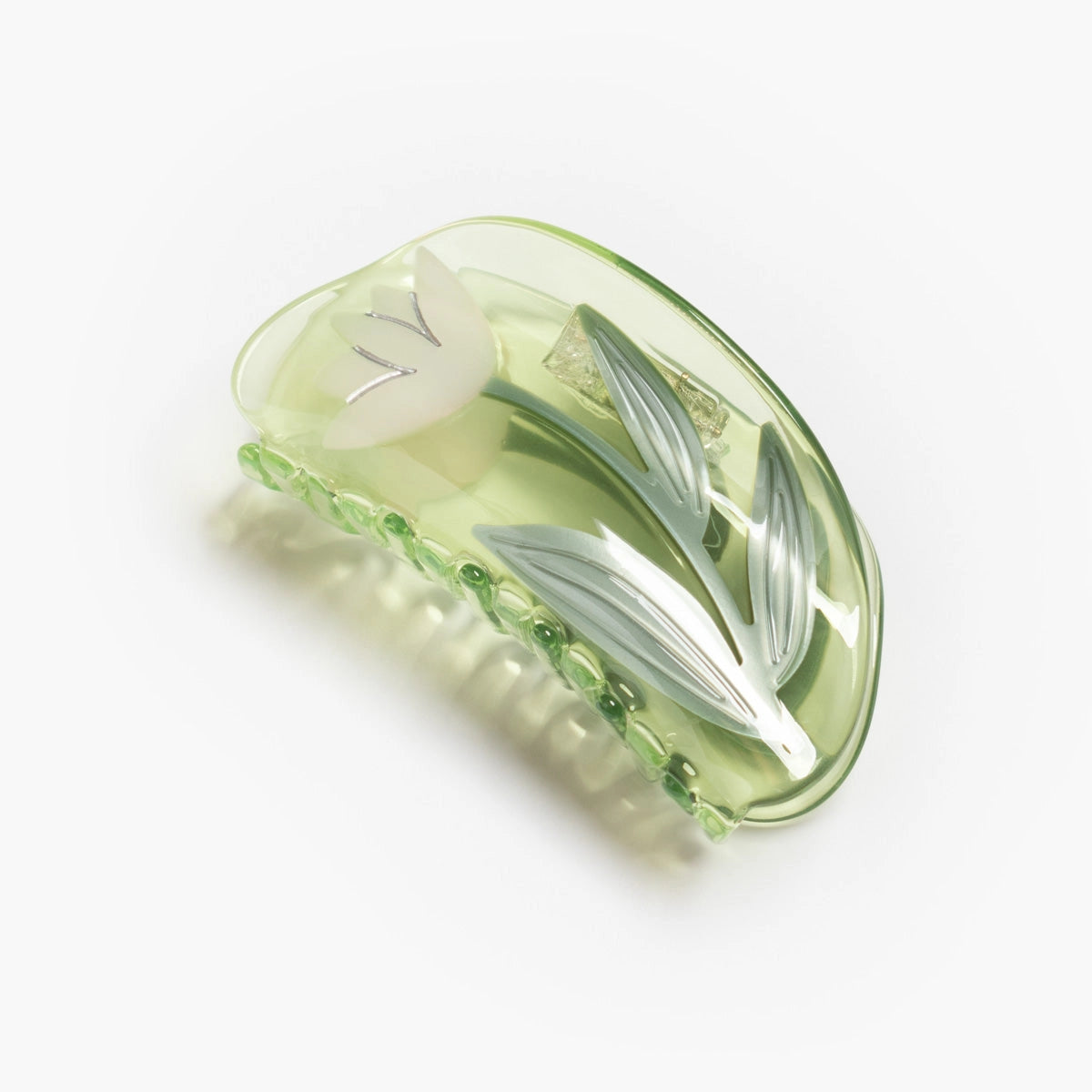 Green hair clip with lotus flower design on a white background