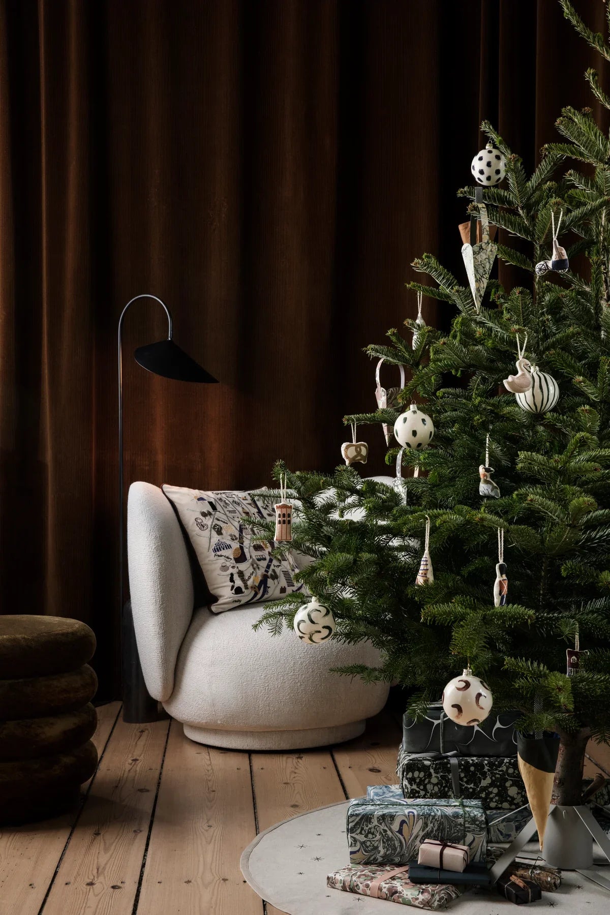 Christmas tree decorations at Lifestory - A Christmas tree in a living room with Baubles hanging from it