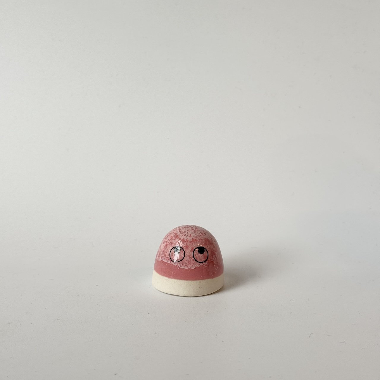Luca, a pink Studio Arhoj 'Dot' set against a plain light gray background.