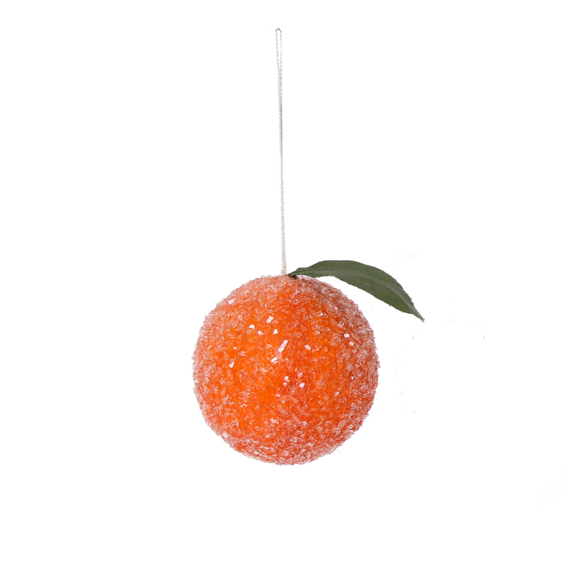 Decorative orange ornament with a green leaf on a white background