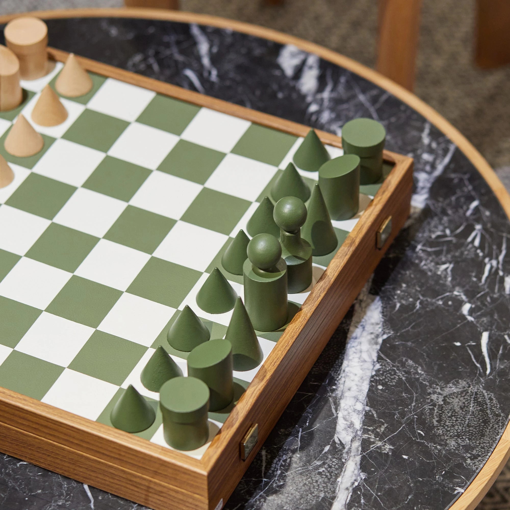 Milos Wooden Chess Set by The Conran Shop in olivine on a marble table